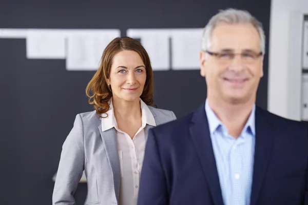 Business woman standing behind co-worker — 스톡 사진