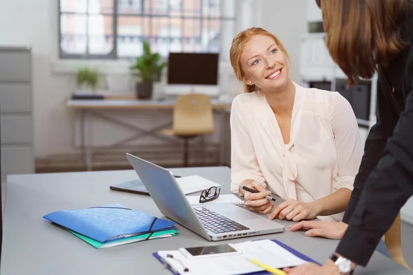 Dos mujeres de negocios disfrutando de una charla amistosa — Foto de Stock