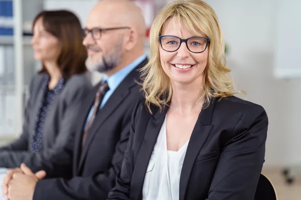 Blond business woman in suit jacket smiles — Stock Photo, Image