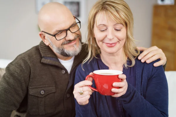 Loving middle-aged couple enjoying a cup of coffee — Stock Photo, Image