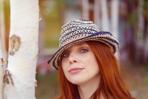 Cute red haired woman in hat among birch trees — Stock Photo, Image