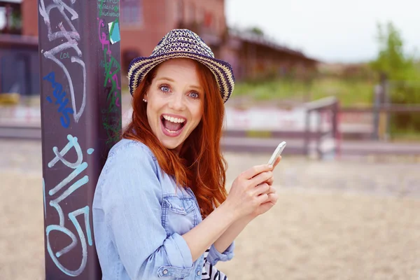 Szczęśliwa kobieta z zaskoczeniem wypowiedzi za pomocą telefonu — Zdjęcie stockowe