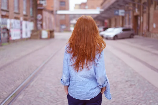 Modaya uygun genç kızıl saçlı kadın şehirde yürüyor — Stok fotoğraf
