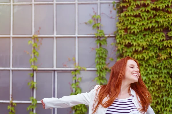 Jaunty young redhead woman posing for the camera — Stock Photo, Image