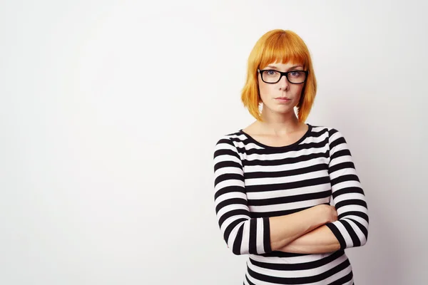 Stern determined young woman with folded arms — Stock Photo, Image