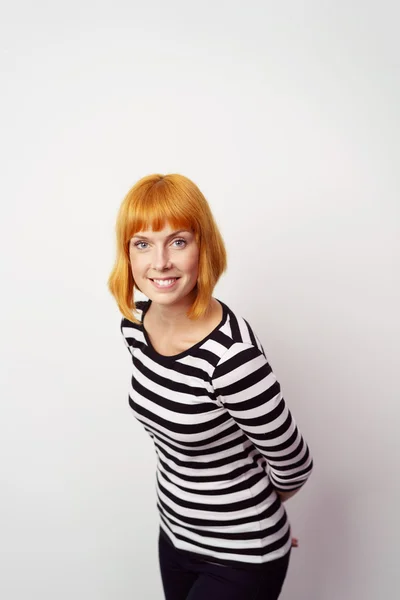 Smiling friendly woman leaning towards the camera — Stock Photo, Image