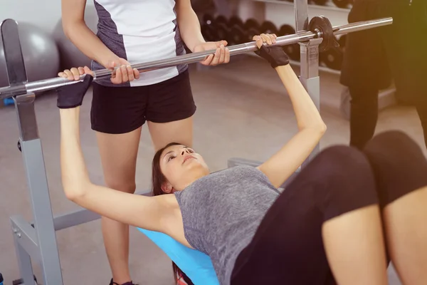 Spotter helping woman during barbell training — Stock Photo, Image