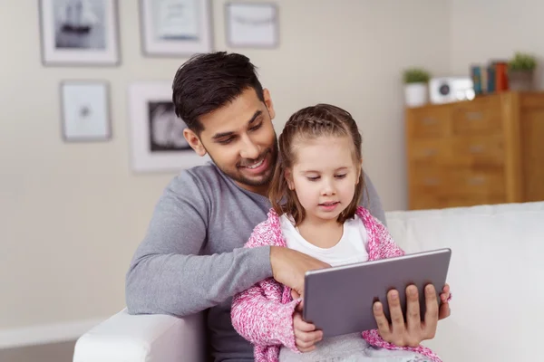 Adorable little girl looking at a tablet — Stock Photo, Image