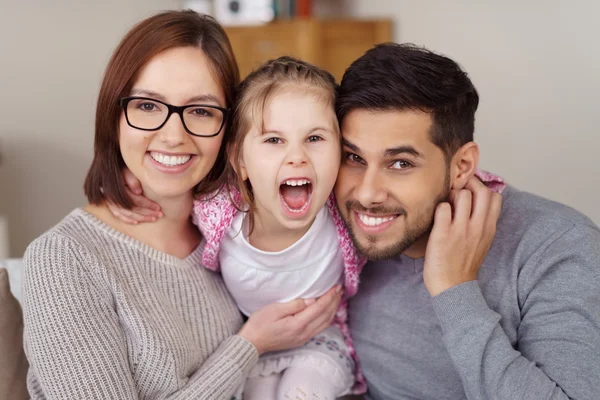 Girl yelling for joy while held by loving parents — Stock Photo, Image