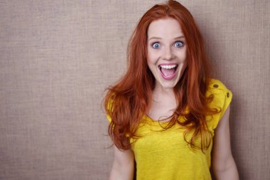 Pretty young redhead with a surprised expression clipart