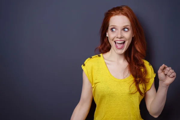 Laughing or overjoyed woman with fist up — Stock Photo, Image