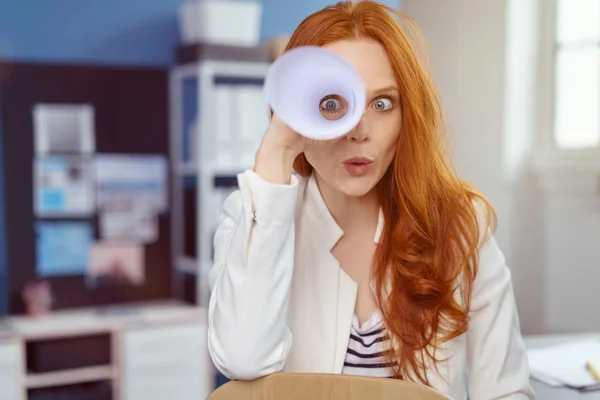 Playful young businesswoman spying on the camera — Stock Photo, Image