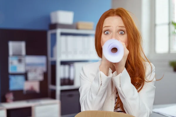 Businesswoman speaking through a megaphone — Stock Photo, Image