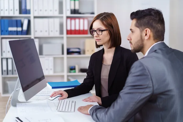 Young business partnership in a serious meeting — Stok fotoğraf