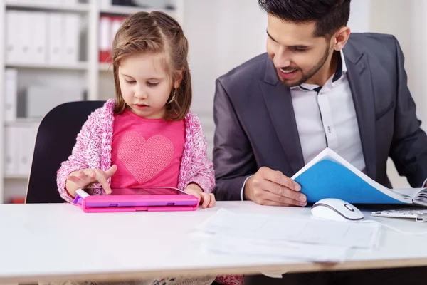 Businessman keeping an eye on his little daughter — Stock Photo, Image