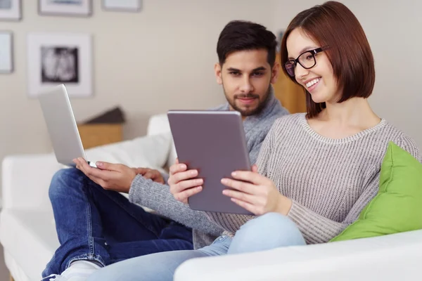 Smiling woman showing her husband something — Stock Photo, Image