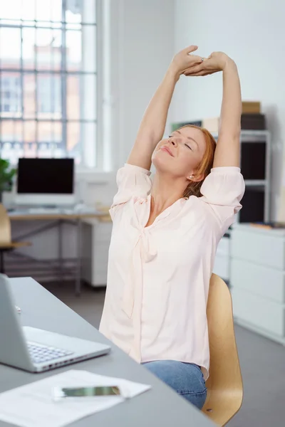 Contented businesswoman stretching to relax — Stock Photo, Image