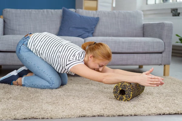 Dame massiert Arme beim Dehnen mit Schaumstoffrolle — Stockfoto