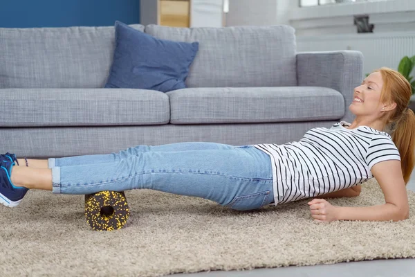 Woman massaging calf muscles with foam roll