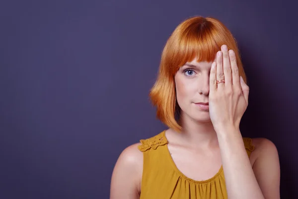 Attractive young woman covering one eye — Stock Photo, Image