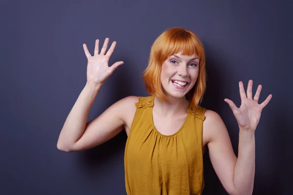 Mischievous young woman grinning at the camera — Stock Photo, Image