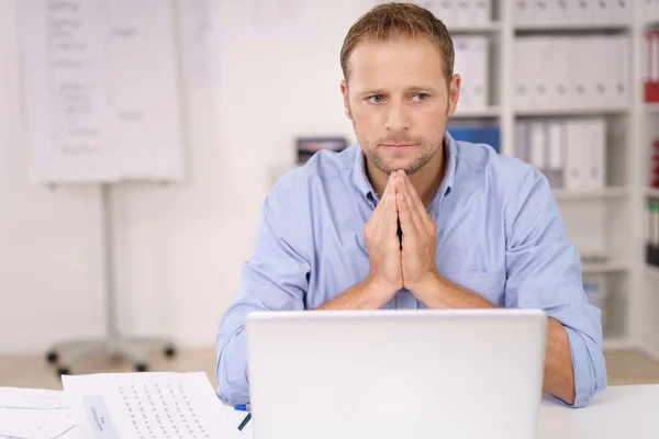 Worried businessman with clasped hands — ストック写真