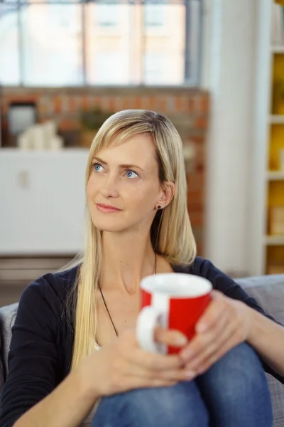 Attractive housewife sitting daydreaming — Stock Photo, Image