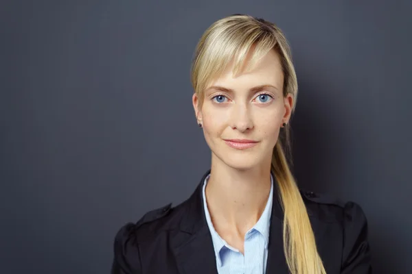 Confident young female over dark background — Stock Photo, Image