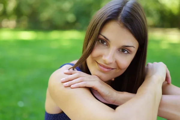 Close up of grinning woman with green space — Stock Photo, Image