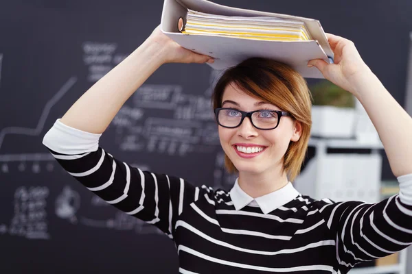 Fun playful businesswoman with a file on her head — Stock Photo, Image