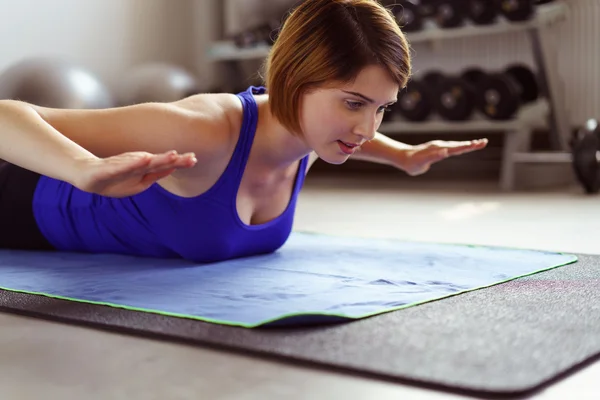 Beautiful woman doing exercises while laying down — Stock Photo, Image