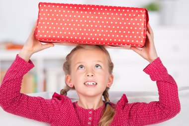 Girl holding wrapped gift box clipart