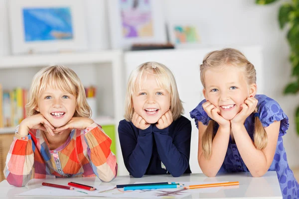 Siblings with drawing papers and pencils — Stock Photo, Image