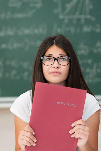 Worried young female student in class — Stock Photo, Image