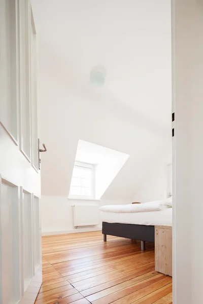 Loft bedroom with sloping ceiling — Stock Photo, Image