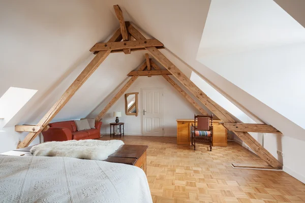 Spacious loft bedroom interior in roof apex — Stock Photo, Image