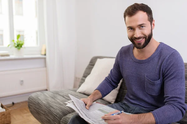 Smiling Middle Age Man Holding Newspaper and Pen — Stock Photo, Image