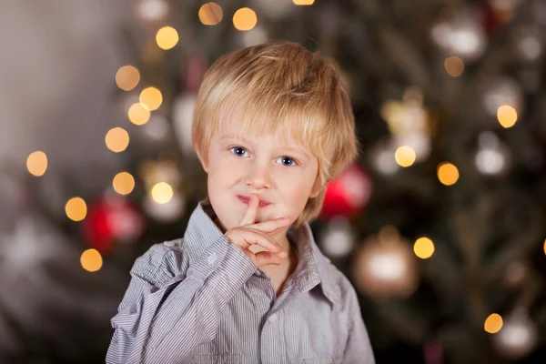 Boy keeping Christmas secret — Stock Photo, Image