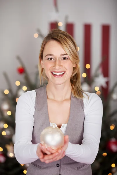 Woman holding christmas decoration — Stock Photo, Image