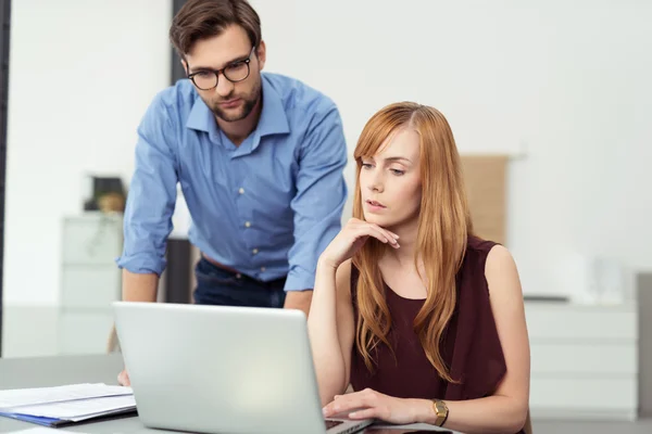 Zakenman helpen een vrouwelijke collega — Stockfoto