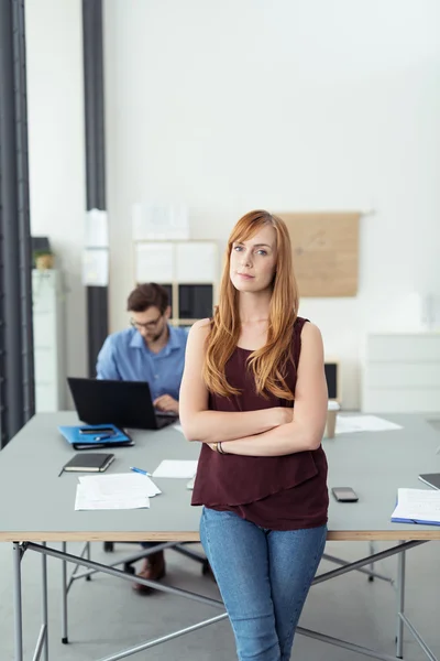 Affärskvinna står med armarna korsade i office — Stockfoto