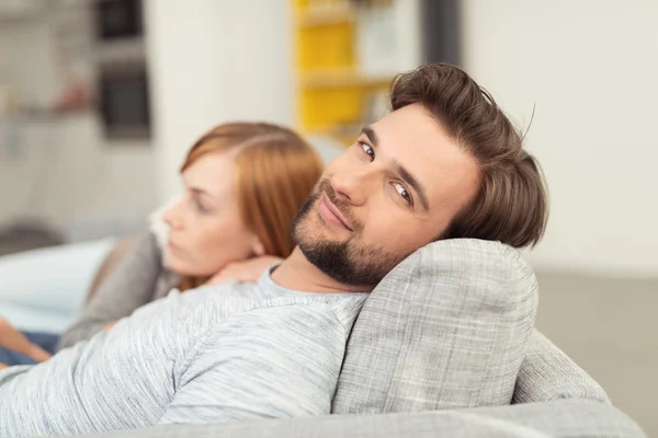 Smiling Man with Head Leaned Back on Sofa Cushion — Stock Photo, Image