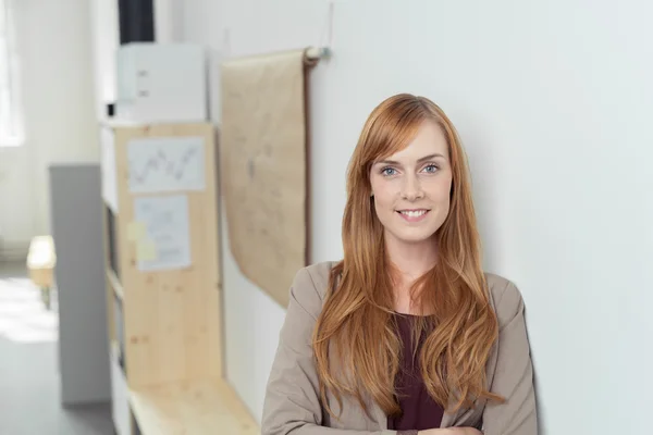 Smiling attractive redhead office worker — Stok fotoğraf