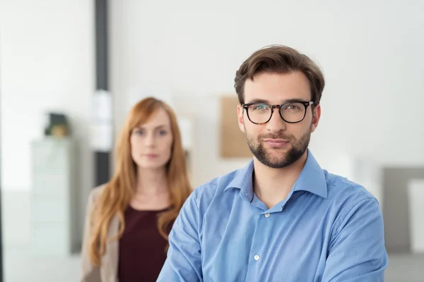 Smiling Bearded Businessman In front his Co-Worker — Stock Fotó