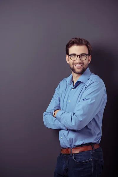 Un hombre de negocios sonriente con los brazos cruzados — Foto de Stock