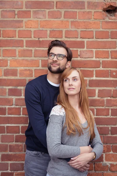 Thoughtful Sweet Couple Against Brick Wall — Stock Fotó