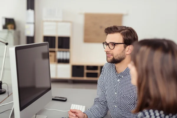 Young employees staring at a turned off PC monitor — Stock Photo, Image