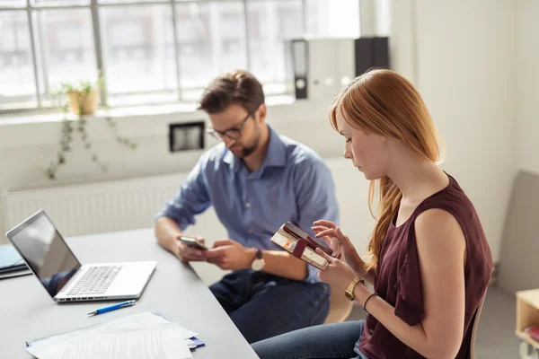 Gente de negocios en la mesa ocupada con los teléfonos —  Fotos de Stock