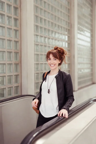 Smiling Pretty Young Lady Taking the Escalator — стокове фото