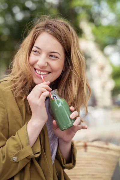 Happy blond tonåring tjej dricker en flaska juice — Stockfoto